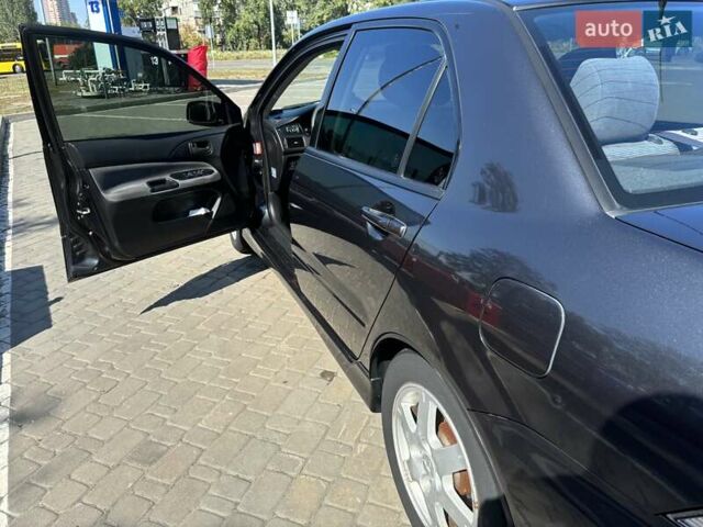 Сірий Міцубісі Lancer, об'ємом двигуна 1.58 л та пробігом 167 тис. км за 5100 $, фото 13 на Automoto.ua