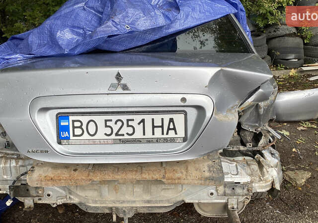 Сірий Міцубісі Lancer, об'ємом двигуна 1.58 л та пробігом 270 тис. км за 1999 $, фото 22 на Automoto.ua
