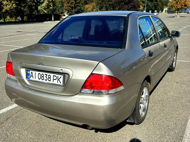 Серый Мицубиси Лансер, объемом двигателя 1.3 л и пробегом 245 тыс. км за 3000 $, фото 2 на Automoto.ua