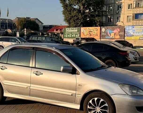 Серый Мицубиси Лансер, объемом двигателя 1.6 л и пробегом 275 тыс. км за 3500 $, фото 1 на Automoto.ua