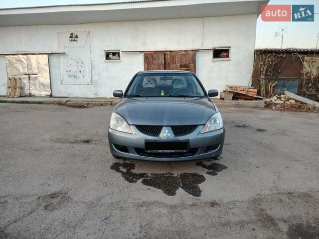 Сірий Міцубісі Lancer, об'ємом двигуна 1.58 л та пробігом 300 тис. км за 4200 $, фото 11 на Automoto.ua