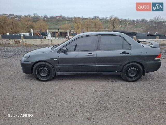 Серый Мицубиси Лансер, объемом двигателя 1.6 л и пробегом 305 тыс. км за 4000 $, фото 7 на Automoto.ua