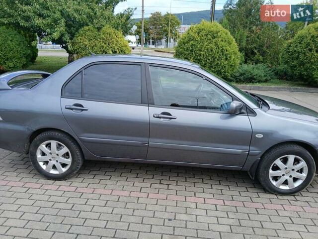 Сірий Міцубісі Lancer, об'ємом двигуна 1.58 л та пробігом 200 тис. км за 4000 $, фото 7 на Automoto.ua