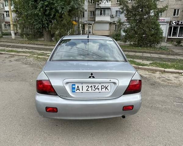 Серый Мицубиси Лансер, объемом двигателя 1.58 л и пробегом 165 тыс. км за 3800 $, фото 1 на Automoto.ua