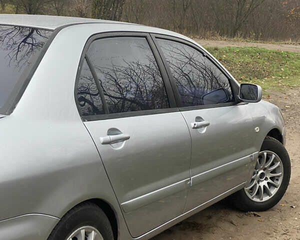 Серый Мицубиси Лансер, объемом двигателя 1.58 л и пробегом 210 тыс. км за 3900 $, фото 2 на Automoto.ua