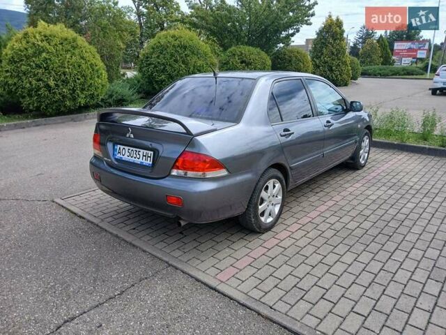 Сірий Міцубісі Lancer, об'ємом двигуна 1.58 л та пробігом 200 тис. км за 4000 $, фото 3 на Automoto.ua