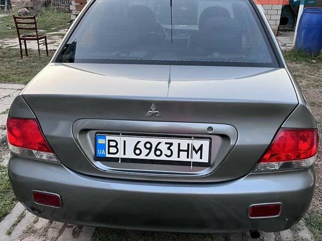 Серый Мицубиси Лансер, объемом двигателя 1.58 л и пробегом 290 тыс. км за 4000 $, фото 3 на Automoto.ua