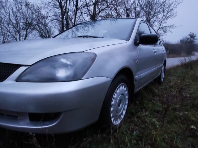 Серый Мицубиси Лансер, объемом двигателя 1.6 л и пробегом 235 тыс. км за 2850 $, фото 20 на Automoto.ua