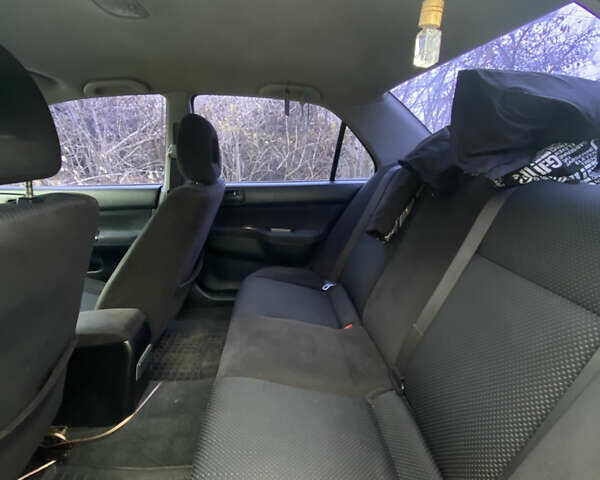 Серый Мицубиси Лансер, объемом двигателя 1.58 л и пробегом 210 тыс. км за 3900 $, фото 9 на Automoto.ua