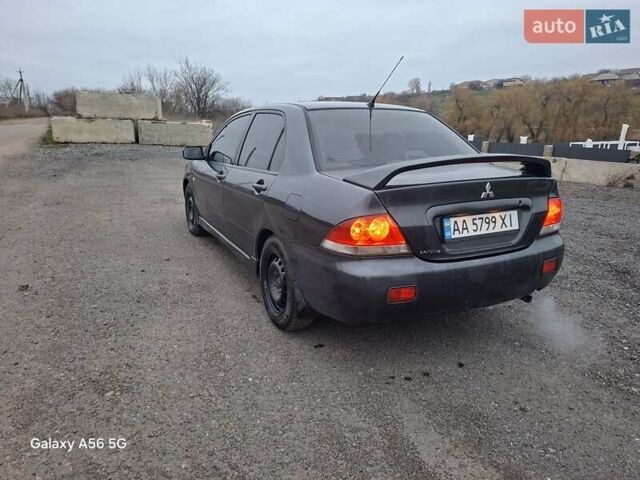 Серый Мицубиси Лансер, объемом двигателя 1.6 л и пробегом 305 тыс. км за 4000 $, фото 3 на Automoto.ua