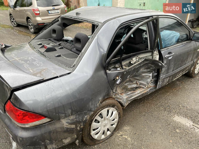 Сірий Міцубісі Lancer, об'ємом двигуна 1.58 л та пробігом 97 тис. км за 2000 $, фото 5 на Automoto.ua