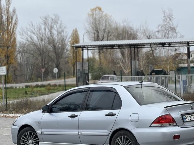 Серый Мицубиси Лансер, объемом двигателя 1.6 л и пробегом 250 тыс. км за 2600 $, фото 1 на Automoto.ua