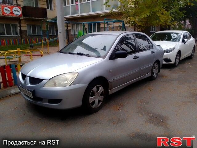 Сірий Міцубісі Lancer, об'ємом двигуна 1.6 л та пробігом 360 тис. км за 1999 $, фото 5 на Automoto.ua