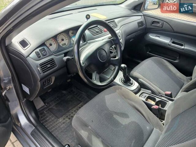 Сірий Міцубісі Lancer, об'ємом двигуна 1.58 л та пробігом 200 тис. км за 4000 $, фото 9 на Automoto.ua