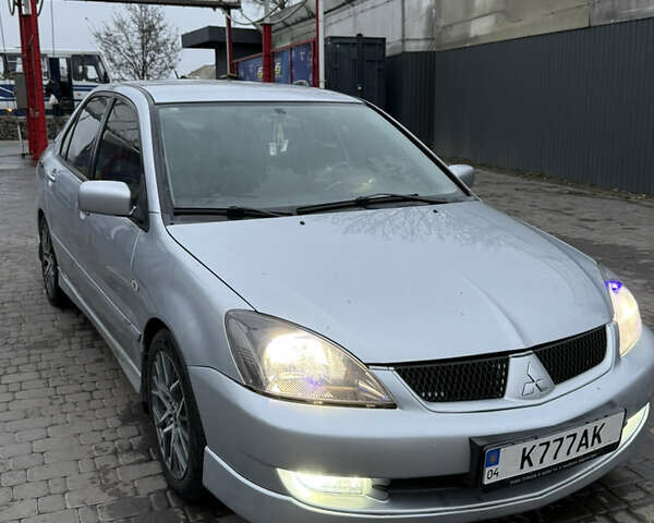 Серый Мицубиси Лансер, объемом двигателя 2 л и пробегом 256 тыс. км за 7000 $, фото 1 на Automoto.ua