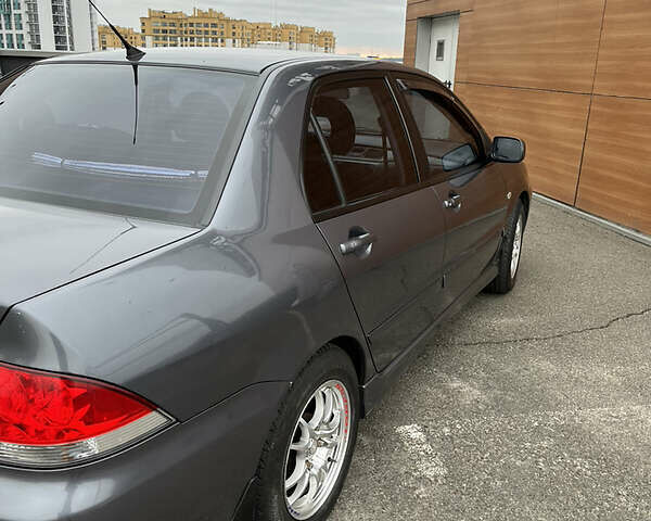 Сірий Міцубісі Lancer, об'ємом двигуна 1.6 л та пробігом 260 тис. км за 4998 $, фото 24 на Automoto.ua