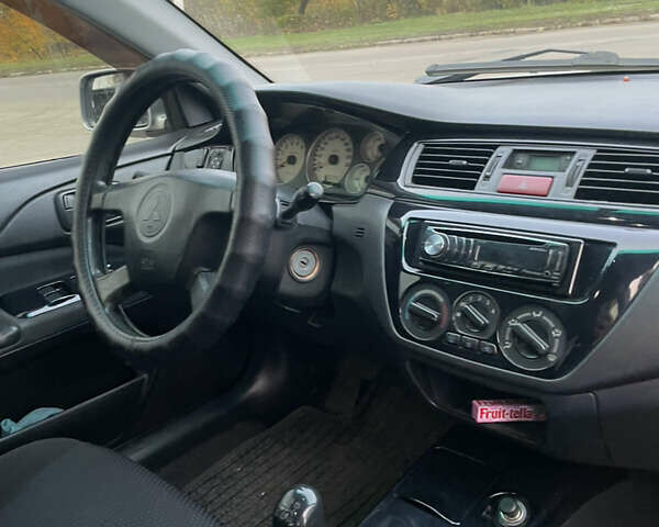Сірий Міцубісі Lancer, об'ємом двигуна 1.58 л та пробігом 430 тис. км за 2550 $, фото 9 на Automoto.ua