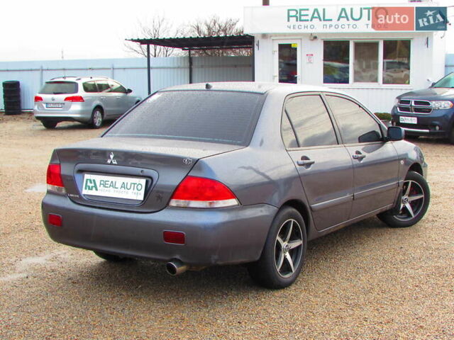 Серый Мицубиси Лансер, объемом двигателя 1.58 л и пробегом 300 тыс. км за 3600 $, фото 2 на Automoto.ua