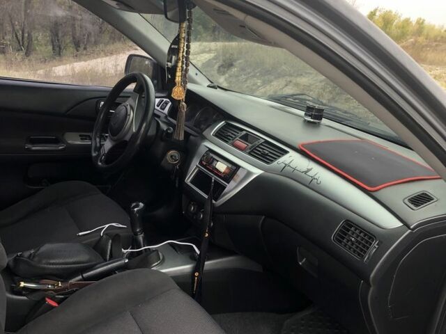 Міцубісі Lancer 2006 у Синельниковом на Automoto.ua Сірий Міцубісі Lancer, об'ємом двигуна 2 л та пробігом 200 тис. км за 3000 $, фото 4 на Automoto.ua