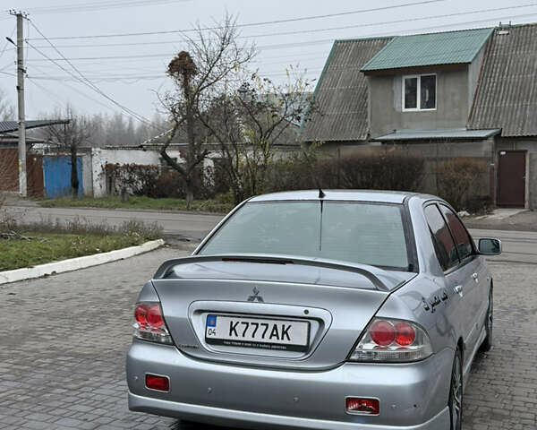 Серый Мицубиси Лансер, объемом двигателя 2 л и пробегом 256 тыс. км за 7000 $, фото 3 на Automoto.ua