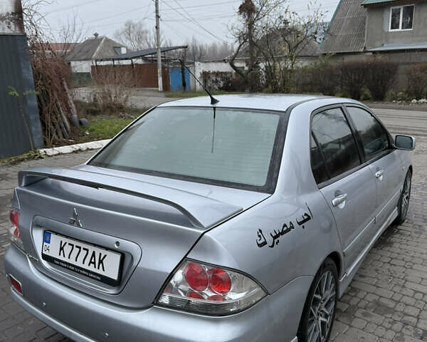 Серый Мицубиси Лансер, объемом двигателя 2 л и пробегом 256 тыс. км за 7000 $, фото 4 на Automoto.ua