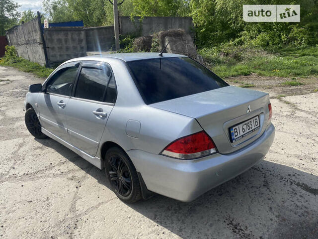 Сірий Міцубісі Lancer, об'ємом двигуна 1.58 л та пробігом 211 тис. км за 3999 $, фото 7 на Automoto.ua