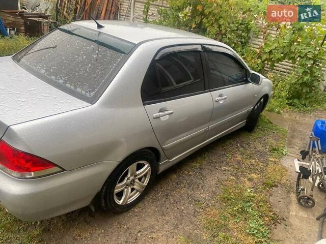 Сірий Міцубісі Lancer, об'ємом двигуна 1.58 л та пробігом 238 тис. км за 5000 $, фото 5 на Automoto.ua