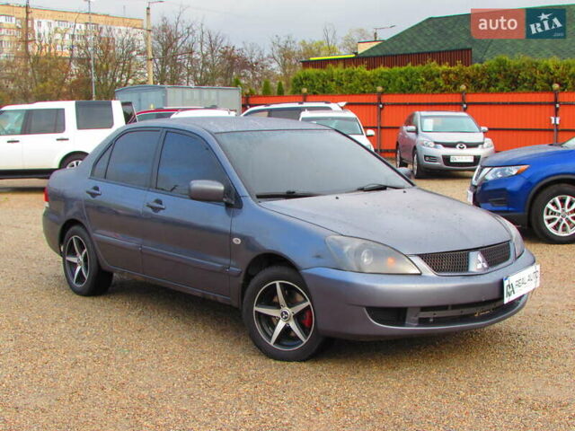 Серый Мицубиси Лансер, объемом двигателя 1.58 л и пробегом 300 тыс. км за 3600 $, фото 3 на Automoto.ua