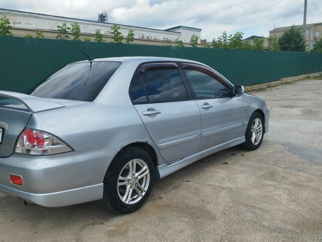 Серый Мицубиси Лансер, объемом двигателя 2 л и пробегом 306 тыс. км за 4100 $, фото 5 на Automoto.ua