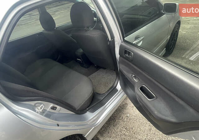 Серый Мицубиси Лансер, объемом двигателя 2 л и пробегом 230 тыс. км за 4000 $, фото 3 на Automoto.ua