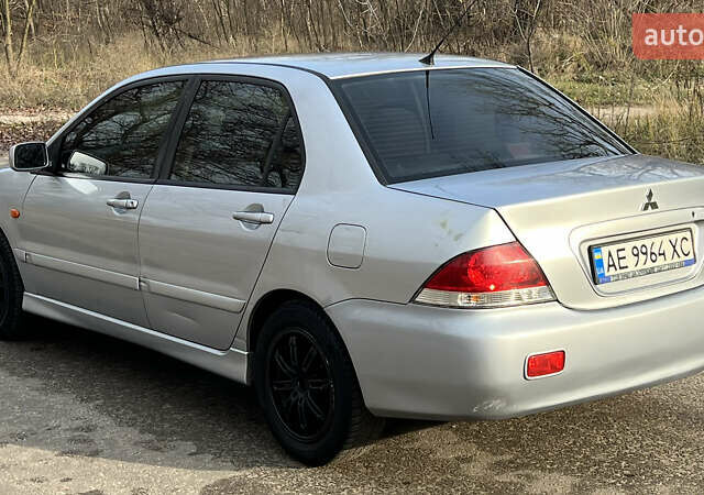 Серый Мицубиси Лансер, объемом двигателя 1.58 л и пробегом 290 тыс. км за 3750 $, фото 1 на Automoto.ua