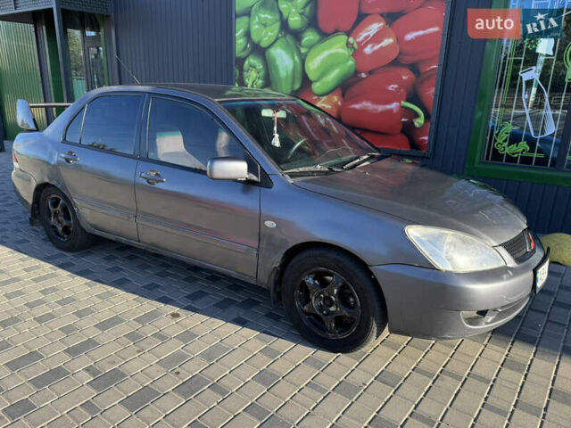 Сірий Міцубісі Lancer, об'ємом двигуна 1.58 л та пробігом 341 тис. км за 2200 $, фото 5 на Automoto.ua