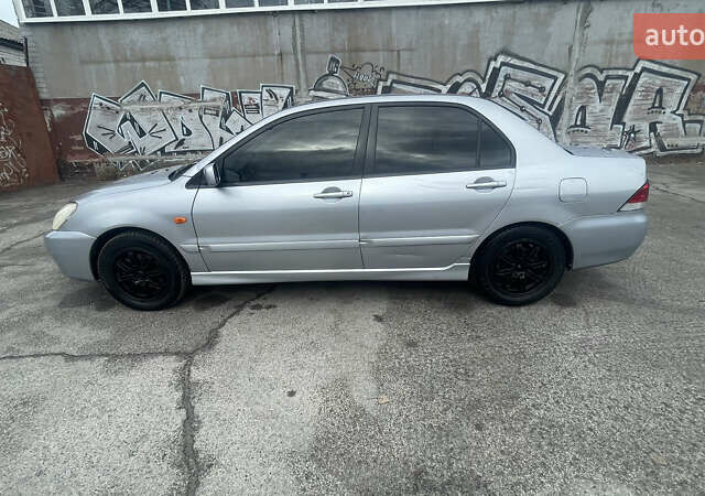 Серый Мицубиси Лансер, объемом двигателя 2 л и пробегом 230 тыс. км за 4000 $, фото 5 на Automoto.ua