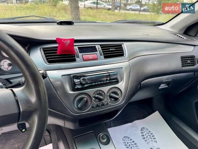 Сірий Міцубісі Lancer, об'ємом двигуна 1.58 л та пробігом 138 тис. км за 4990 $, фото 28 на Automoto.ua