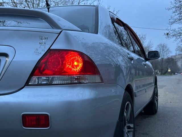 Сірий Міцубісі Lancer, об'ємом двигуна 1.6 л та пробігом 210 тис. км за 4750 $, фото 4 на Automoto.ua
