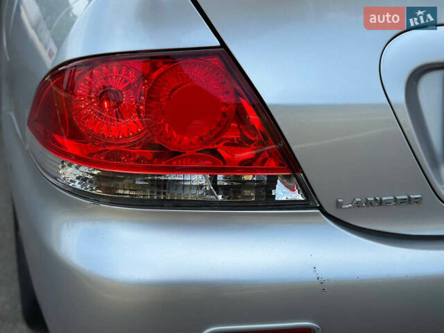 Сірий Міцубісі Lancer, об'ємом двигуна 1.58 л та пробігом 181 тис. км за 5699 $, фото 41 на Automoto.ua