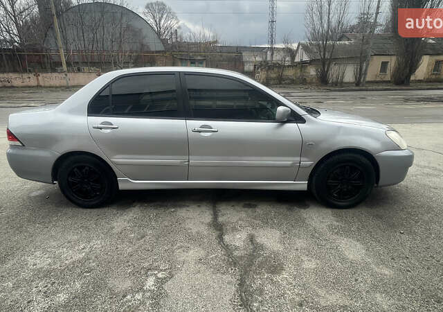 Серый Мицубиси Лансер, объемом двигателя 2 л и пробегом 230 тыс. км за 4000 $, фото 1 на Automoto.ua