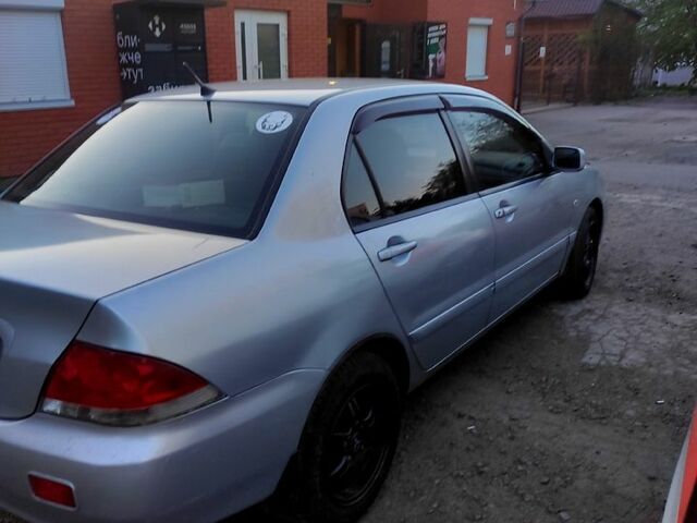 Серый Мицубиси Лансер, объемом двигателя 1.6 л и пробегом 302 тыс. км за 3200 $, фото 1 на Automoto.ua