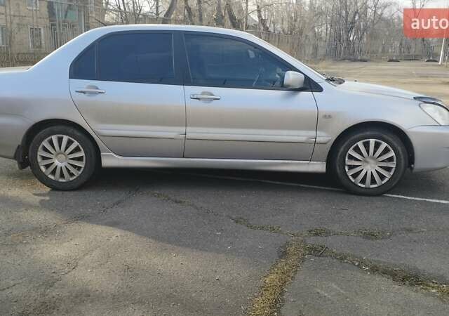 Серый Мицубиси Лансер, объемом двигателя 1.6 л и пробегом 205 тыс. км за 4500 $, фото 2 на Automoto.ua