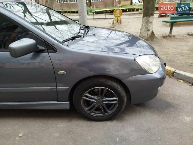 Сірий Міцубісі Lancer, об'ємом двигуна 1.58 л та пробігом 250 тис. км за 4750 $, фото 4 на Automoto.ua