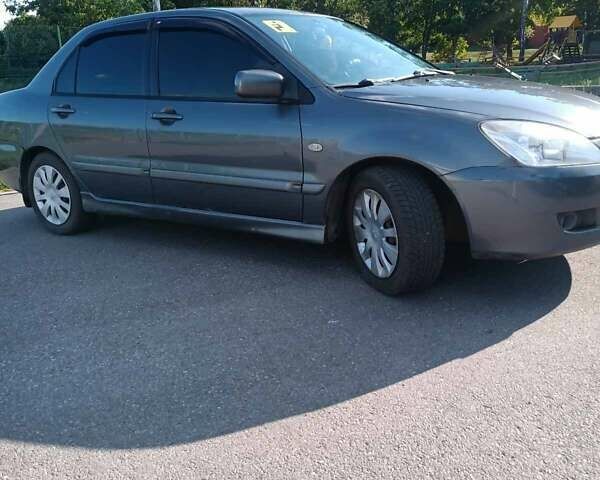 Серый Мицубиси Лансер, объемом двигателя 1.58 л и пробегом 300 тыс. км за 4400 $, фото 4 на Automoto.ua