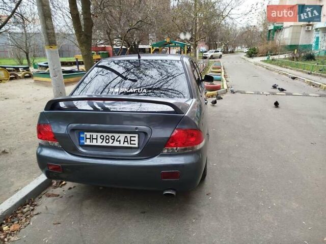 Сірий Міцубісі Lancer, об'ємом двигуна 1.58 л та пробігом 250 тис. км за 4750 $, фото 6 на Automoto.ua