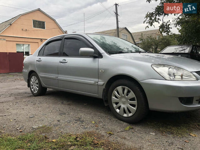 Сірий Міцубісі Lancer, об'ємом двигуна 1.58 л та пробігом 240 тис. км за 4299 $, фото 1 на Automoto.ua