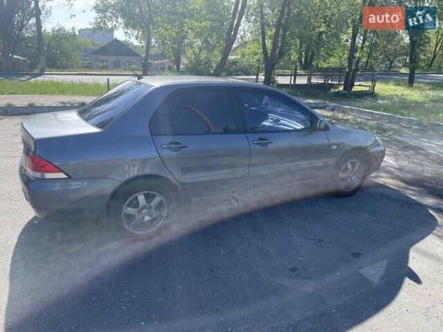 Серый Мицубиси Лансер, объемом двигателя 1.58 л и пробегом 210 тыс. км за 5000 $, фото 4 на Automoto.ua