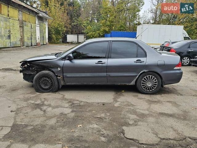 Сірий Міцубісі Lancer, об'ємом двигуна 1.58 л та пробігом 200 тис. км за 1700 $, фото 5 на Automoto.ua