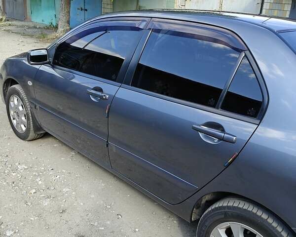 Сірий Міцубісі Lancer, об'ємом двигуна 1.58 л та пробігом 97 тис. км за 6800 $, фото 4 на Automoto.ua