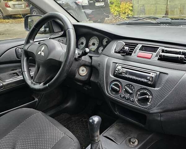 Сірий Міцубісі Lancer, об'ємом двигуна 1.58 л та пробігом 200 тис. км за 1700 $, фото 15 на Automoto.ua