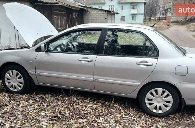 Серый Мицубиси Лансер, объемом двигателя 1.58 л и пробегом 89 тыс. км за 7500 $, фото 2 на Automoto.ua