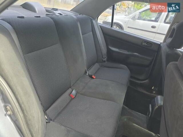 Сірий Міцубісі Lancer, об'ємом двигуна 1.58 л та пробігом 298 тис. км за 3400 $, фото 7 на Automoto.ua