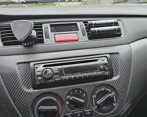 Сірий Міцубісі Lancer, об'ємом двигуна 1.58 л та пробігом 200 тис. км за 1700 $, фото 13 на Automoto.ua
